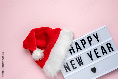 Wallpaper Mural White lightbox with text HAPPY NEW YEAR and Santa Claus hat on pink backdrop. Minimal Christmas or New Year concept. Torontodigital.ca