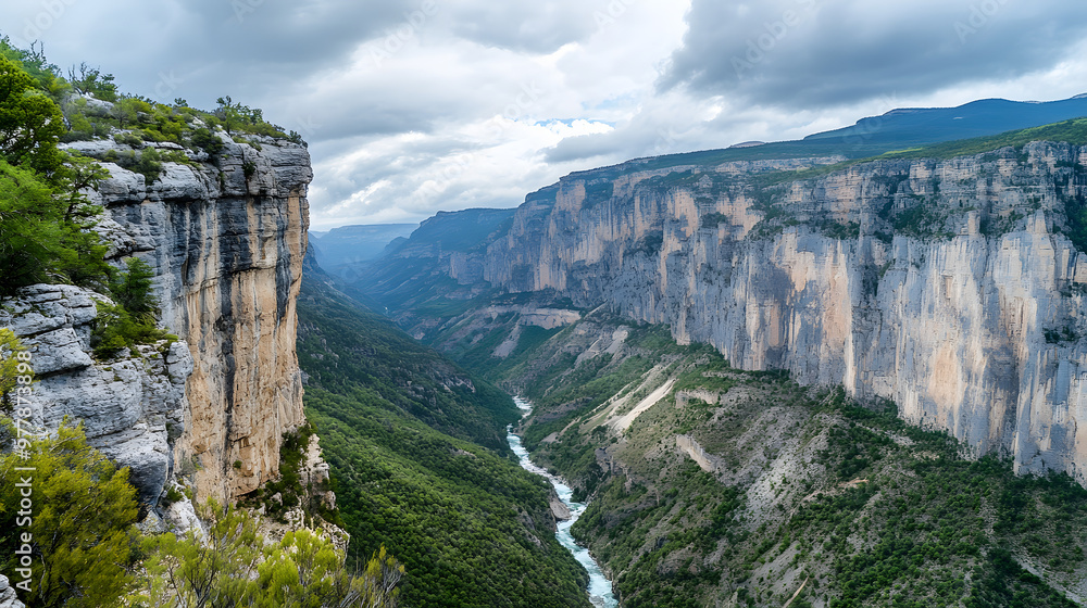 A deep mountain canyon with sheer cliffs carved by a fast-flowing river that winds through the valley below. A deep mountain canyon with sheer cliffs carved by a fast-flowing river that winds through the valley below.