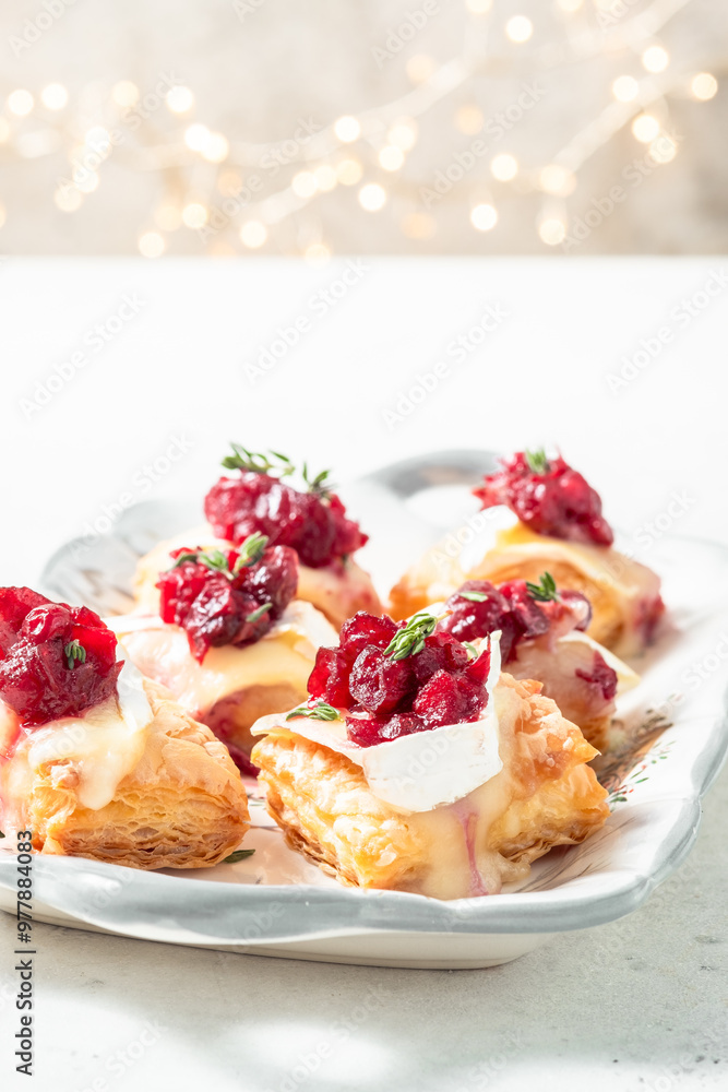 A tray of food with cranberries and cream on top A tray of food with cranberries and cream on top