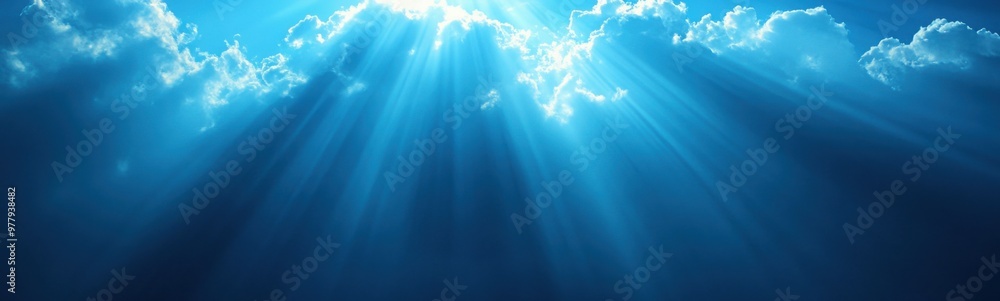 Sunlight shining through the clouds in a blue sky Sunlight shining through the clouds in a blue sky