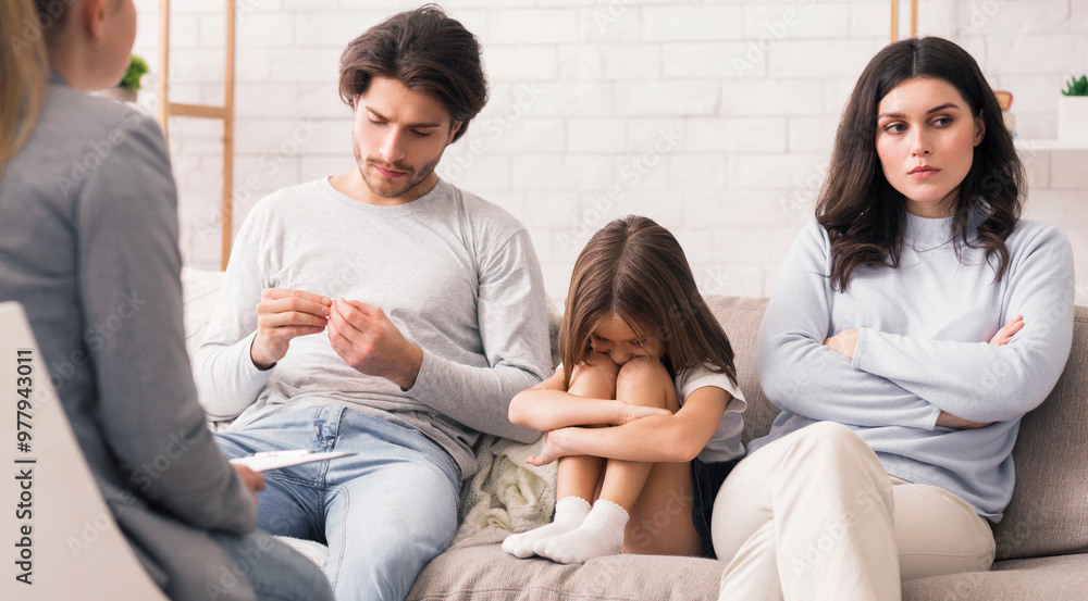 Family Counselling Concept. Unhappy Man And Woman And Their Upset Little Daughter Sitting At Psychologist's Office, Having Therapy Family Counselling Concept. Unhappy Man And Woman And Their Upset Little Daughter Sitting At Psychologist's Office, Having Therapy