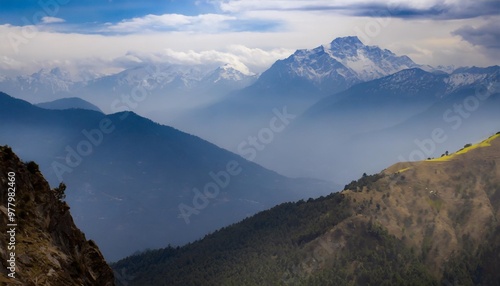 Majestic Mountain Range at Sunrise, Illuminating the Sky with Warm Colors