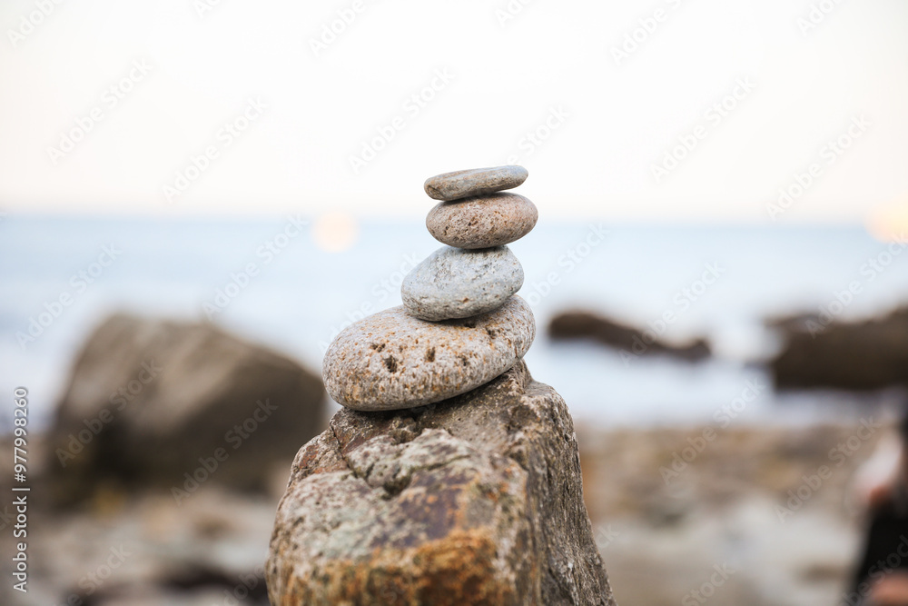 serene beach scene with smooth rocks stacked in a balanced formation. The tranquil atmosphere evokes a sense of zen, harmony, and peace, symbolizing balance and mindfulness in nature serene beach scene with smooth rocks stacked in a balanced formation. The tranquil atmosphere evokes a sense of zen, harmony, and peace, symbolizing balance and mindfulness in nature