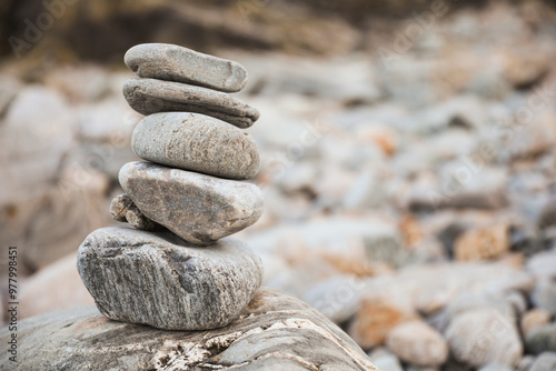 serene beach scene with smooth rocks stacked in a balanced formation. The tranquil atmosphere evokes a sense of zen, harmony, and peace, symbolizing balance and mindfulness in nature photo