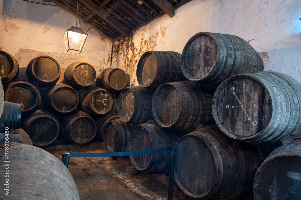 Solera system in old Andalusian wine cellar, process for aging sherry wine in barrels, fino, manzanilla, olorosso, amontillado jerez fortified wine, Sanlucar de Barrameda, Cadiz, Andalusia, Spain Solera system in old Andalusian wine cellar, process for aging sherry wine in barrels, fino, manzanilla, olorosso, amontillado jerez fortified wine, Sanlucar de Barrameda, Cadiz, Andalusia, Spain