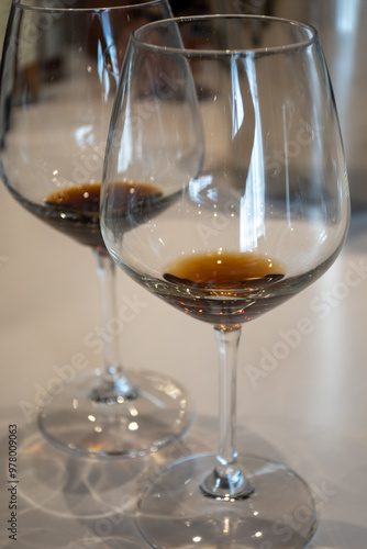 Tasting of sweet Bordeaux white wine in Sauternes, left bank of Gironde Estuary, France. Glasses of white sweet French wine served in restaurant