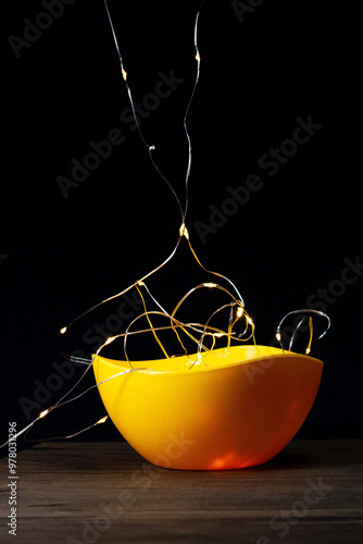 Lights in a yellow pot. Decoration.