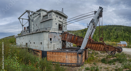 Old historic dredging machine used in gold mining at Dawson City, Yukon, Canada photo