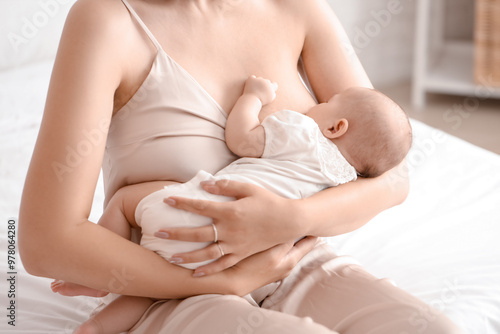 Young woman breastfeeding h...