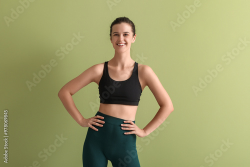 Sporty young woman on green...