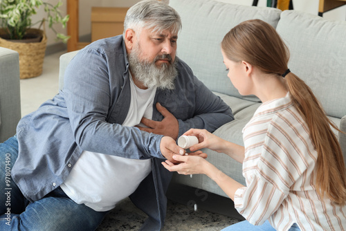 Young woman giving medicine...