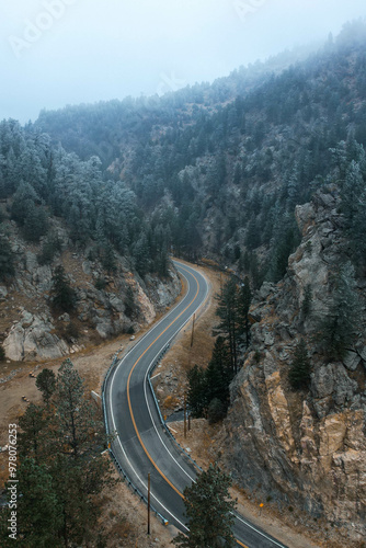 Aerial view of a winding road through misty mountains, perfect for travel, outdoor adventure, and scenic nature projects. Ideal for editorial use, travel content, or adventure branding.