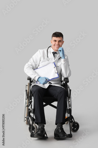 Young male doctor in wheelc...