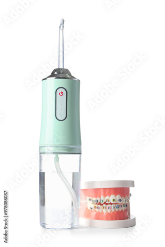 Oral irrigator and jaw model on white background photo