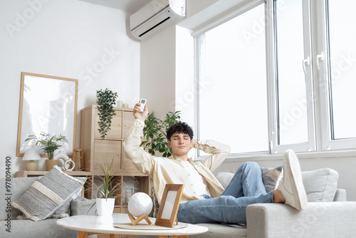 Young man resting on sofa i...