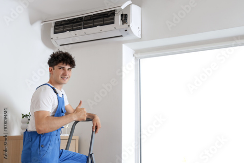 Male worker repairing air c...