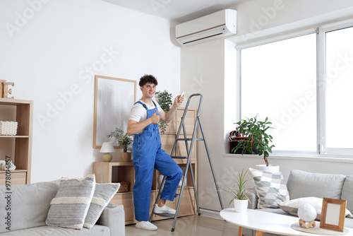 Male worker repairing air c...