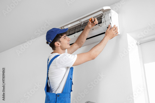 Male worker repairing air c...