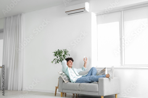 Young man resting on sofa i...