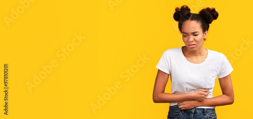 Period Pain. Sad black girl holding hands on stomach suffering from abdominal pain. Panorama, copy space photo