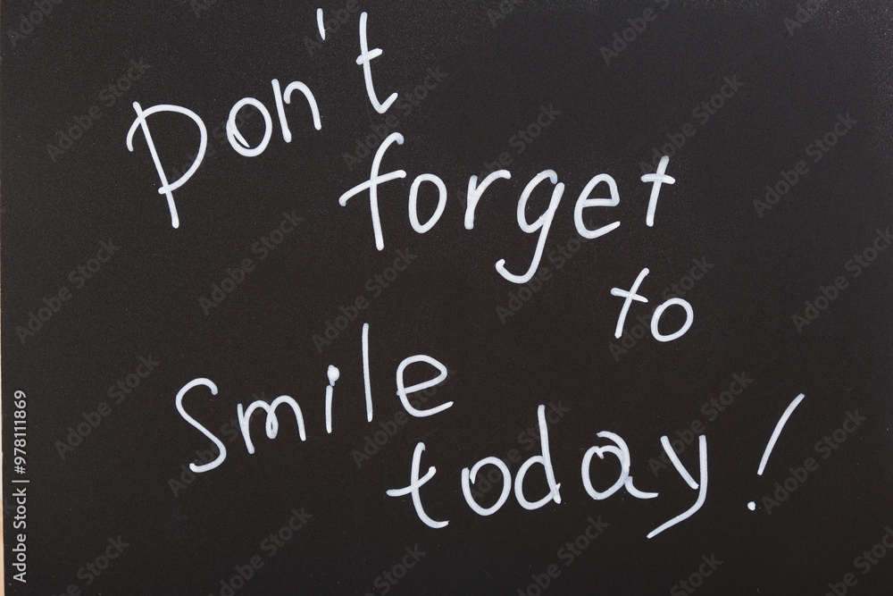 don't forget to smile today inscription, text with white chalk marker on black board, motivation for the day, top view don't forget to smile today inscription, text with white chalk marker on black board, motivation for the day, top view