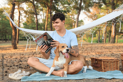 Young man with Beagle dog a...