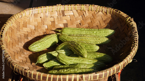 Bitter melon in a bamboo basket exposed to the morning sun. Focus selected photo