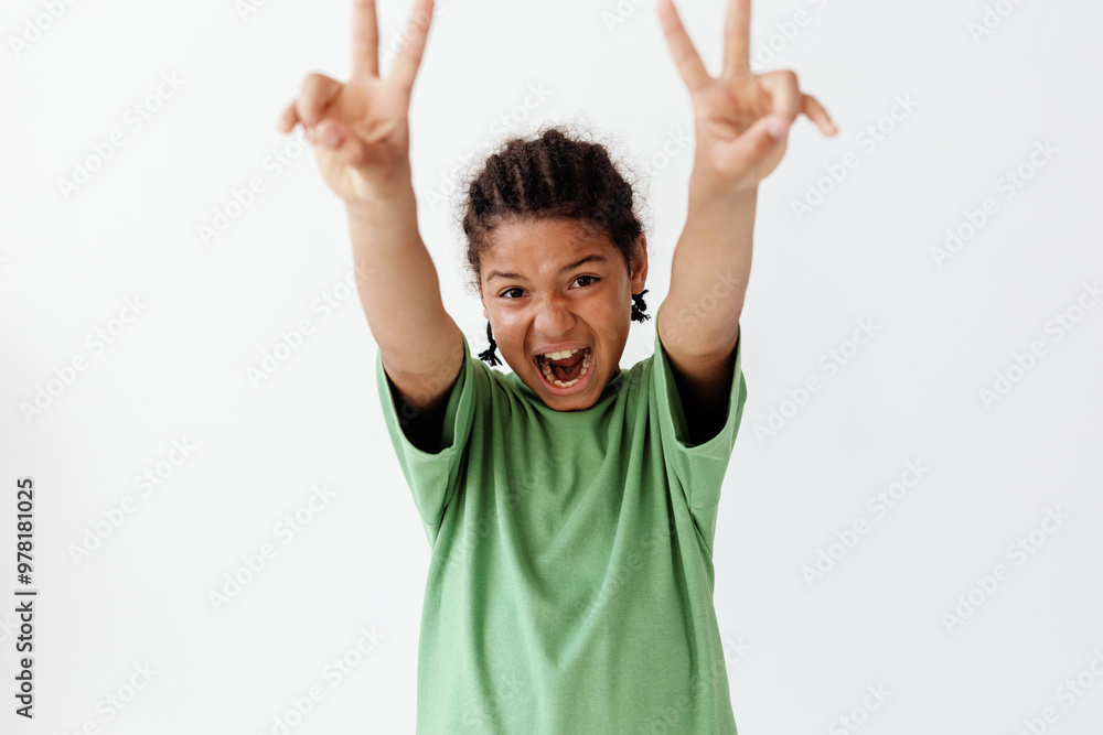 stylish young boy in green shirt flashing peace signs with both hands, exuding trendy vibes stylish young boy in green shirt flashing peace signs with both hands, exuding trendy vibes