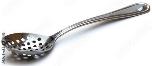 Fototapeta Naklejka Na Ścianę i Meble -  Closeup of a shiny stainless steel kitchen utensil with a perforated design isolated on a plain white background  Useful cooking or serving tool for the modern kitchen or restaurant