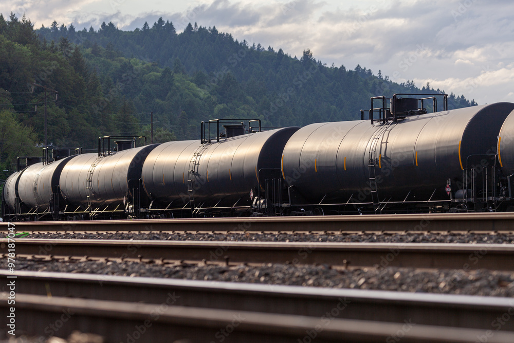 Naklejka premium Black tank cars cisterns for gas and oil, captured in Portland, Oregon industrial area. High quality close up picture for download.
