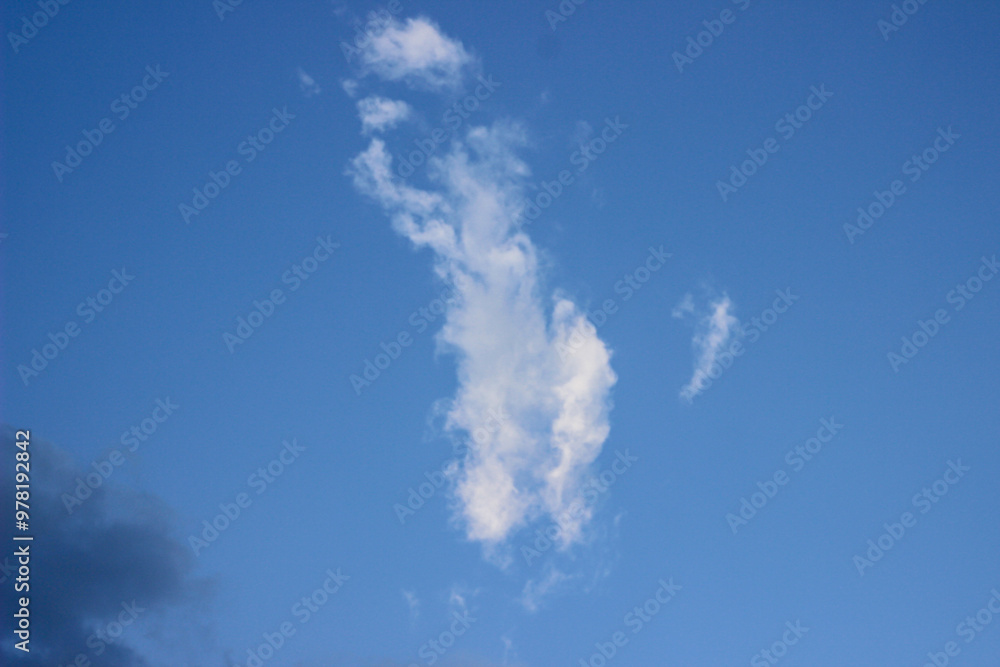 Sun shining through the puffy clouds. Sky view. Beautiful sunny sky. Background with clouds on blue sky Sun shining through the puffy clouds. Sky view. Beautiful sunny sky. Background with clouds on blue sky