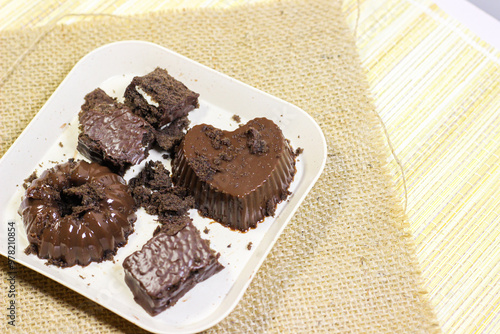 Chocolate pudding on white plate with woven tablecloth isolated photo