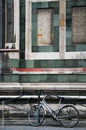 Vintage bicycle by historic stone wall in Firenze, Italy photo