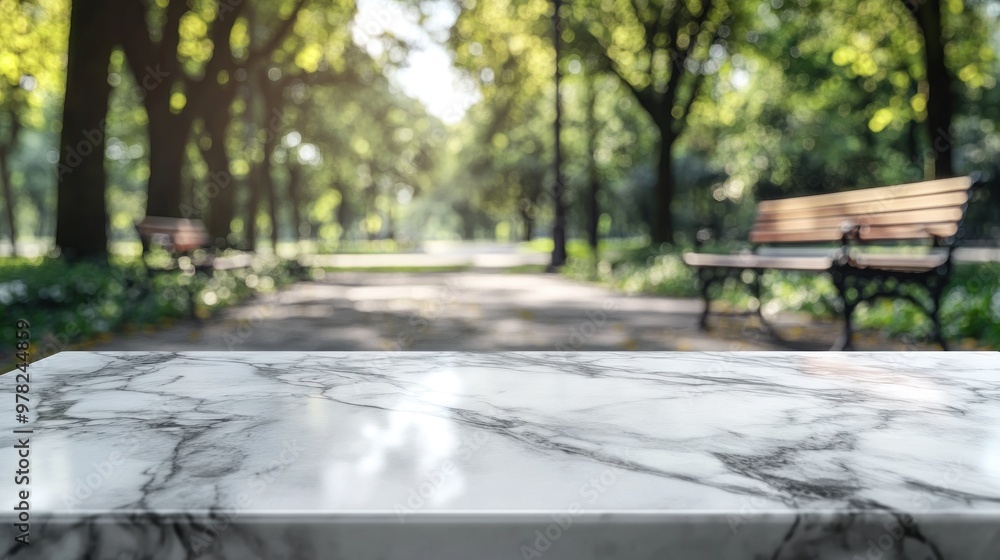 A marble tabletop in a serene park setting with benches and greenery in the background. A marble tabletop in a serene park setting with benches and greenery in the background.