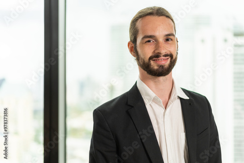 Portrait of confident young businessman standing exuding professionalism poise active and dynamic work in modern office, business, leadership, professional men, office life and career success.