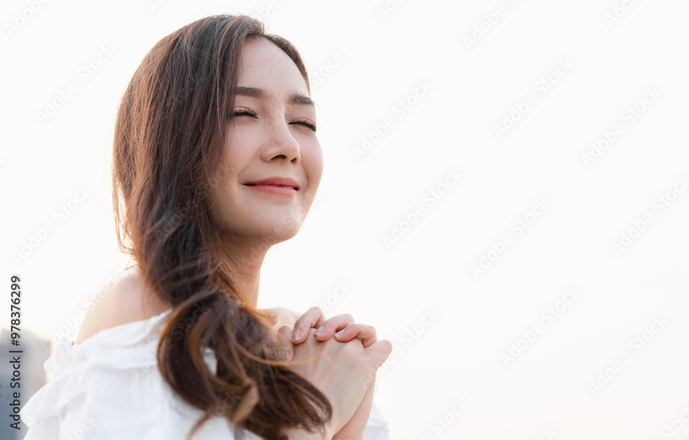 Asian woman smiling with eyes closed feeling peaceful and serene, relaxing outdoor in natural sunlight, enjoying the moment, positive thinking concept, self-love and wellness, fresh air breathing Asian woman smiling with eyes closed feeling peaceful and serene, relaxing outdoor in natural sunlight, enjoying the moment, positive thinking concept, self-love and wellness, fresh air breathing