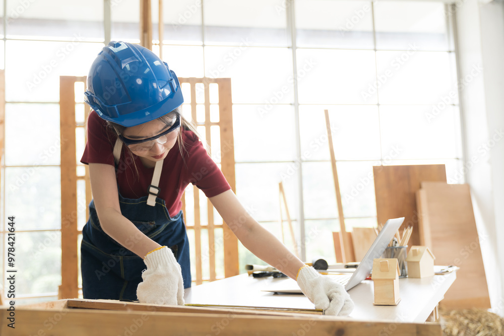Asian woman carpenter working and building furniture at wood workshop. Asian joiner woman making furniture at furniture workshop Asian woman carpenter working and building furniture at wood workshop. Asian joiner woman making furniture at furniture workshop