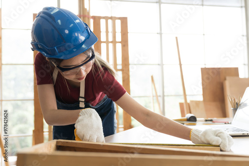 Asian woman carpenter working and building furniture at wood workshop. Asian joiner woman making furniture at furniture workshop