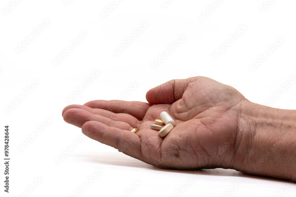Vitamins and medicinal pills held in hand, symbol of health and wellness, copy space, selective focus. Vitamins and medicinal pills held in hand, symbol of health and wellness, copy space, selective focus.