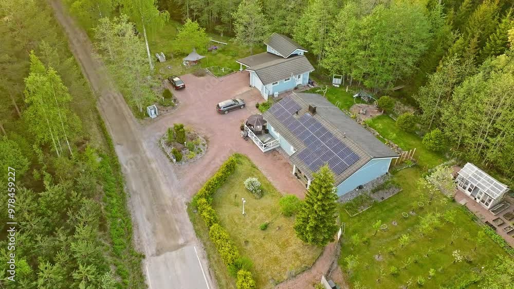 High angle drone shot away from a home with a solar panel roof, summer evening High angle drone shot away from a home with a solar panel roof, summer evening