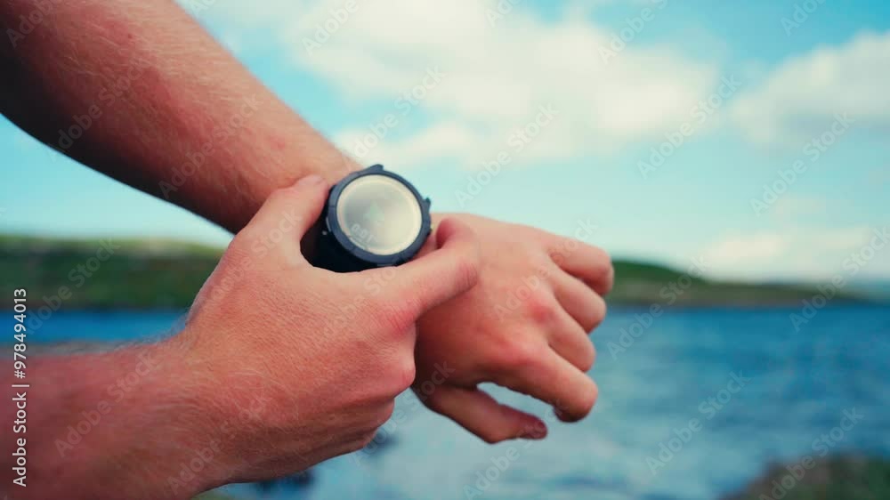 Smartwatch In The Wrist Of A Caucasian Man Over Hiking Trails. Selective Focus Shot Smartwatch In The Wrist Of A Caucasian Man Over Hiking Trails. Selective Focus Shot