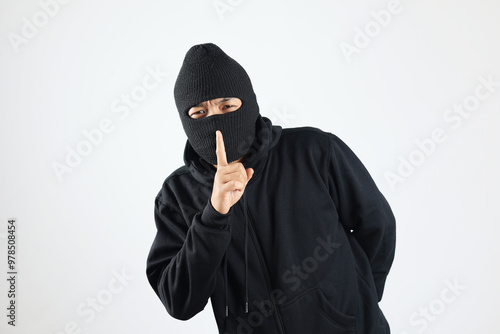 Bilde på lerret Thief in Black Balaclava Holding Fingers on Lips, Making Hush Sign