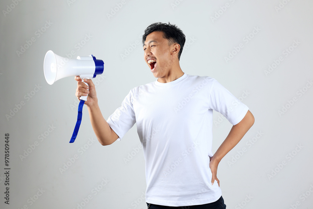 Asian Young Man in White T shirt Shouting Using Megaphone Asian Young Man in White T shirt Shouting Using Megaphone