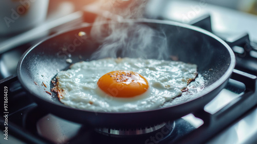 Fried egg sizzling in pan, releasing steam and aroma