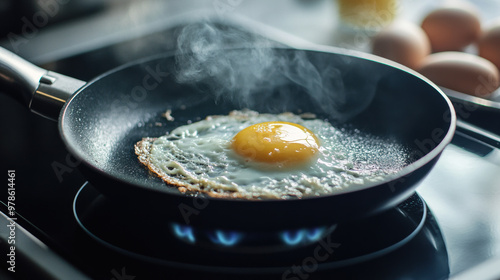 Frying an egg in pan, with steam rising, creates warm and inviting atmosphere