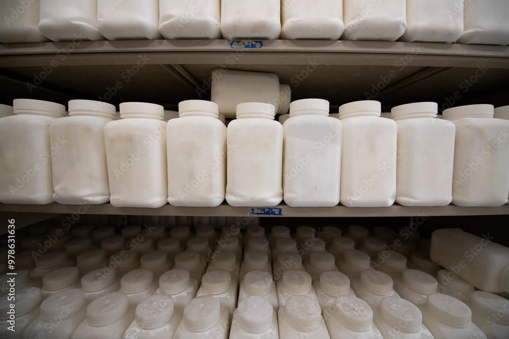 Shelves full of containers with white powder compound samples Shelves full of containers with white powder compound samples