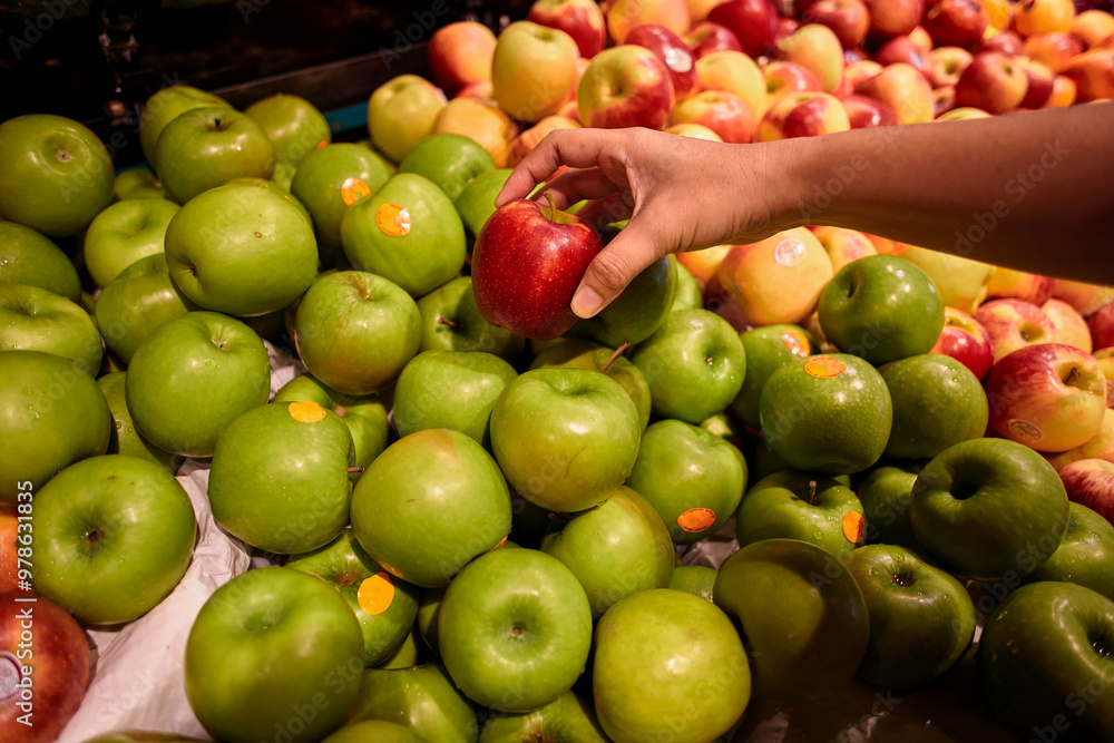 Close-up of hand holding red apple in market Close-up of hand holding red apple in market