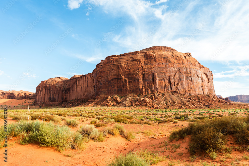 Massive sandstone formation under a bright sky in Monument Valley Massive sandstone formation under a bright sky in Monument Valley