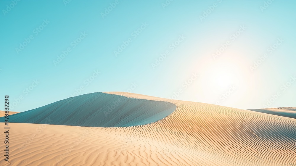 Naklejka premium A serene desert landscape with gentle dunes and a clear blue sky, illuminated by the warm sunlight.