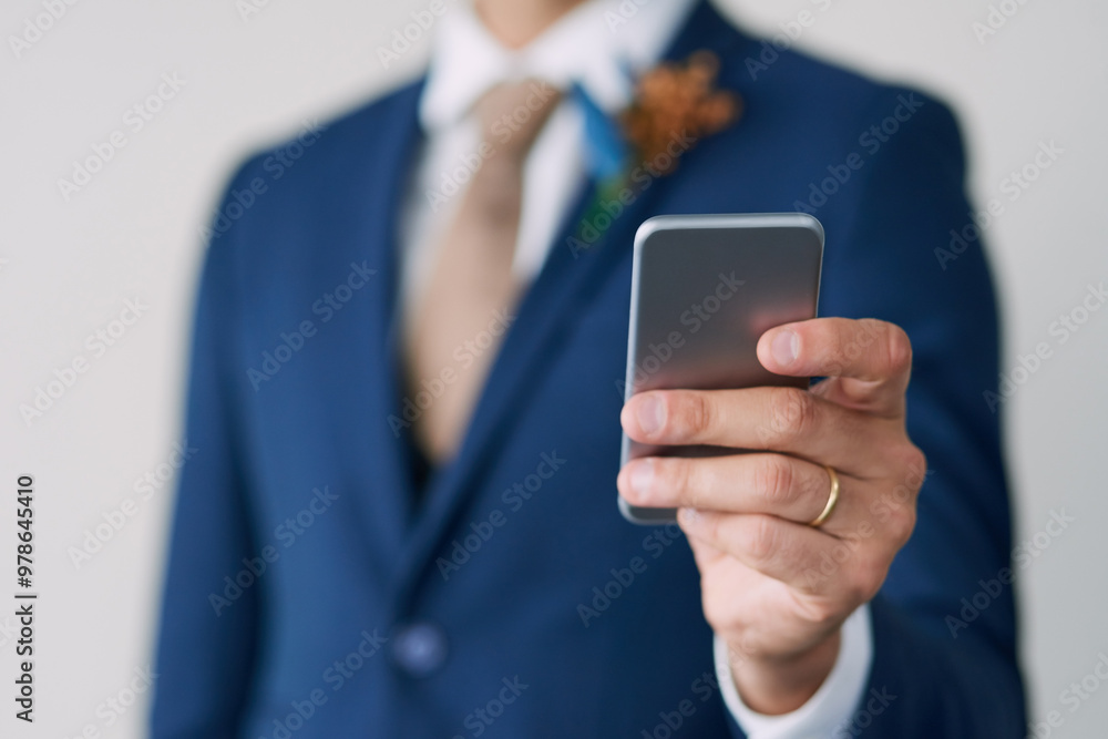 Hand, groom and smartphone in studio for marriage with smile, wedding schedule and relationship trust. Social media, status update and commitment for man, excited and partnership on white background Hand, groom and smartphone in studio for marriage with smile, wedding schedule and relationship trust. Social media, status update and commitment for man, excited and partnership on white background